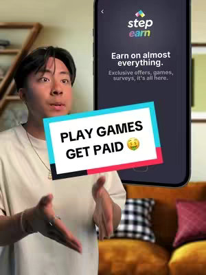 A young man is holding a phone showing the Step app. The phone screen displays text about earning money through games and surveys. Overlaid on the image are colorful text boxes that say 'PLAY GAMES GET PAID'. The man is situated in front of a soft background and holding the phone with both hands.