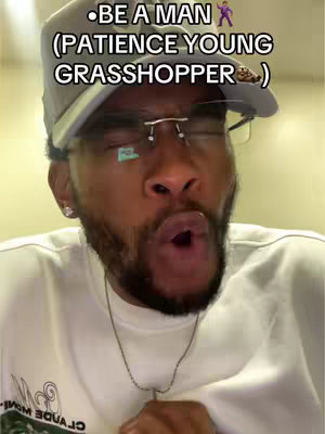 A man wearing a gray cap and glasses opens his mouth wide and looks up, with overlaid text above his head.