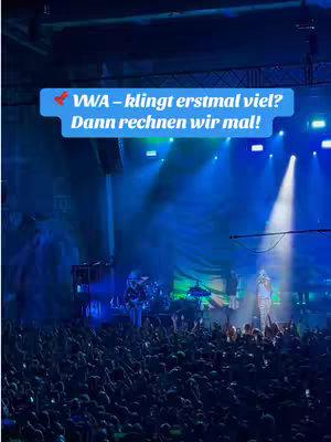 The cover image shows a concert scene. A large crowd of people is visible, with their hands raised. On stage, a band is performing, illuminated by spotlights and stage lights. Text overlay in a speech bubble is visible.