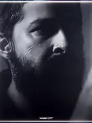 A grayscale, close-up portrait of a man's face, lit from the side. The man has a beard, and visible scars on his face. The background is dark and blurred, with the text 'PEOPLEOFCHRIST' at the bottom.