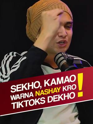 A man in a tan beanie and black jacket is shown from the chest up. He is holding his right hand up to his face, with his fingers partially covering his eye. A microphone is positioned in front of him. A red banner with white text is imposed on the bottom of the image.