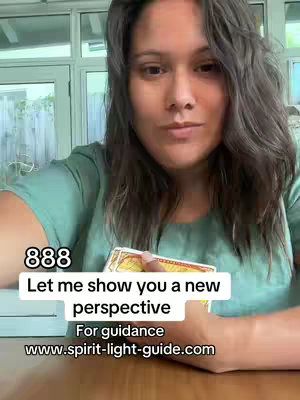 A woman with long, wavy dark hair looks directly at the camera. She wears a green shirt and is holding a deck of tarot cards in her hands. Text overlays indicate the title and the video’s topic is about perspective and guidance, with a website for further information. The background shows a partially visible outdoor setting.