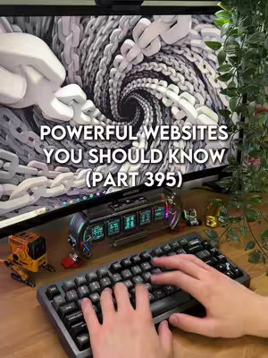 The cover image shows a person typing on a keyboard, in front of a computer screen displaying a swirling chain design. The image has several objects around the keyboard, including a miniature golden statue and a small toy robot.
