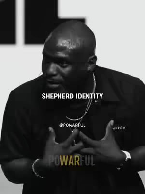 A black and white image features a Black man in a serious pose, with text overlayed. The man is wearing a dark collared shirt and a silver chain necklace. He positions his hands in front of his chest as if he’s presenting or speaking. The text overlay says "SHEPHERD IDENTITY". In the lower portion of the image are the words "POWARFUL" and the @powarful handle.
