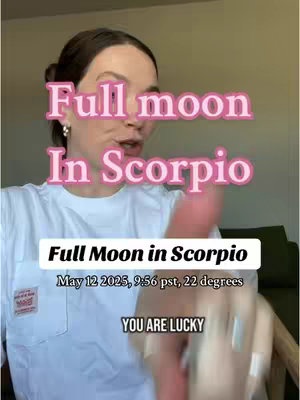 A woman with brown hair is the central subject. Text overlays in pink and white indicate the astrological topic. The woman appears to be speaking directly to the camera, and is wearing a white t-shirt.