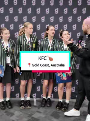 A group of four young women in school uniforms are being interviewed on the street by a man holding a microphone. A graphic overlay indicates that the setting is KFC in Gold Coast, Australia.