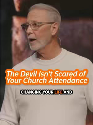 The cover image shows a man wearing glasses and a white shirt. Overlayed on the image is text that states, 'The Devil Isn't Scared of Your Church Attendance' with a smaller text overlay stating 'CHANGING YOUR LIFE AND'