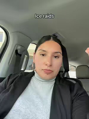 A woman with dark hair is seated inside a vehicle, looking directly at the camera. The background includes elements of the car interior. Overlayed text reads 'ice raids'.