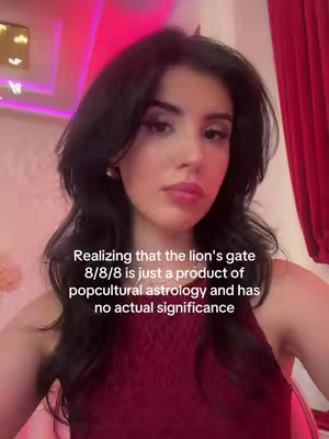 A person, likely a young woman, is the central figure, captured in a medium shot. She has dark hair that frames her face, and she's looking in the camera. She is bathed in a warm lighting, with red wall behind her. Text is overlaid at the bottom, and the focus and composition naturally draw attention to her face.