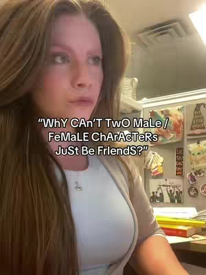 A woman with long brown hair is looking off to the side. The camera is focused on her upper body. A white top is visible, with a light gray suit jacket. Text is overlaid on the image.