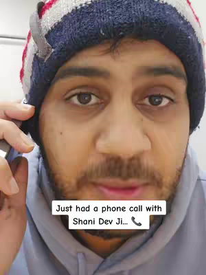 A close-up shot features a man wearing a blue and red striped winter hat. He is on the phone. The background is a light color. Overlay text says, 'Just had a phone call with Shani Dev Ji...'