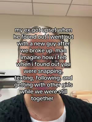A selfie-style video cover shot of a person's face with overlayed text. The person appears to be indoors, potentially in an office setting. The text is overlaid in a white font against a semi-transparent black background and contains grievances for a presumed breakup.