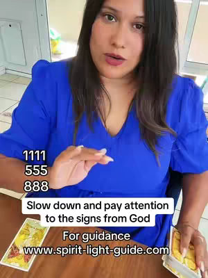 A woman with long, dark hair and a blue top is looking towards the viewer and talking. The image is composed with text overlayed, including numbers and a message about paying attention to signs. There are tarot cards visible in foreground.