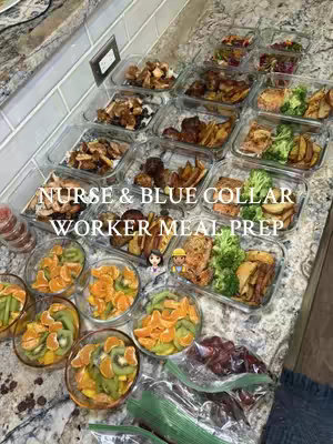 A high-angle shot of a countertop with a meal prep setup. Several clear rectangular containers are filled with various food items, including what appears to be cooked meat, potatoes, broccoli, mandarin orange slices, kiwis, and grapes. The layout suggests multiple meals are prepared for the week. Text overlays at the top in white font, 'NURSE & BLUE COLLAR WORKER MEAL PREP”. The color scheme consists of the natural food colors, a grey countertop, and the clear containers.