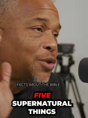 A close-up shot of a man speaking into a microphone. Overlay text announces "Facts About The Bible" and "Five Supernatural Things". The man has short, graying hair and a trimmed beard and mustache. The background is blurred, suggesting a studio or indoor setting.
