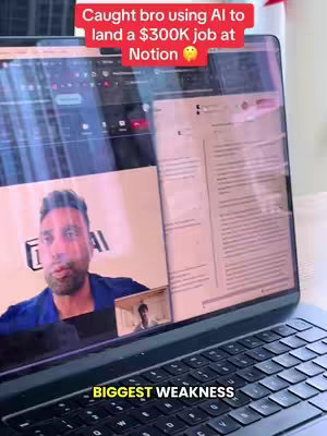 A laptop screen displays a video call with a man, presumably interviewing someone. Overlayed text at the top reads an attention-grabbing message and a subtitle for the interview. The scene is indoors, likely a home or office context.