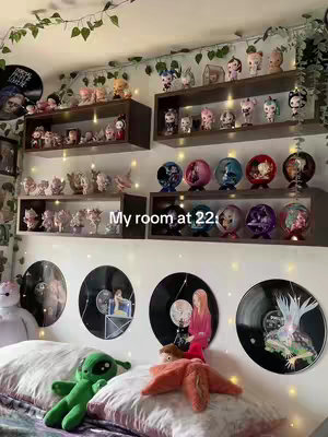A room tour with shelves holding figures is displayed in the image.