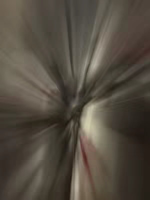 Abstract, blurred image with radial lines emanating from the center, creating an effect of motion or light.