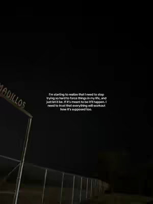 The photo captures a night scene with a dark sky, a partially visible structure on the left, likely a building, and a sign with the letters "ADILLOS." The image is dominated by the color black, suggesting a nighttime setting, and the focus appears to be on the text overlaid on the image.