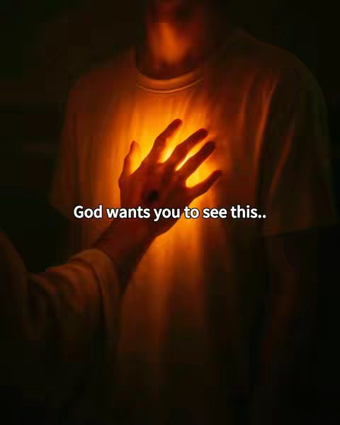 The image shows a person's torso and arm in a dimly lit environment. A hand is reaching towards the chest, with a bright, glowing light emanating from the center like a halo around the heart area. The background is dark, contributing to the focus on the illuminated center, with the text overlayed in clear white font.