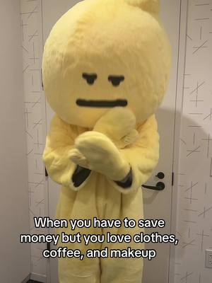 The cover image shows a person in a yellow onion-shaped costume standing in front of closed white doors. The costume has a large, round head with simple black facial features: two small eyes and a horizontal line for a mouth. The person's arms are crossed. Text overlayed at the bottom says 'When you have to save money but you love clothes, coffee, and makeup'.
