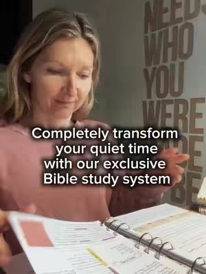 A woman with blonde hair is looking down at a book, likely a Bible study guide. She is wearing a pink shirt. The text on the image states that this is a Bible study system.