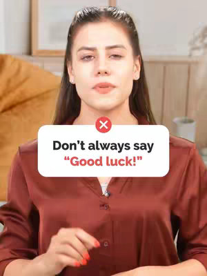 The cover image features a woman facing the camera, within a warm-lit setting. She has long brown hair and is wearing a maroon-colored shirt. Overlaying her is a white speech bubble with a red 'X' symbol, and the text 'Don't always say "Good luck!"'.