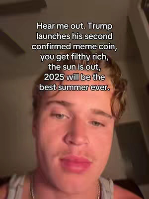 A selfie-style video cover image featuring a young man with light skin, short brown hair, and a light-colored tank top. He is centered in the frame, looking directly at the camera. The background is softly lit, creating a sense of intimacy. Overlay text is prominently displayed at the top, written in a clean, white sans-serif font and includes content about a meme coin.