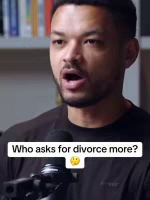 A man with short dark hair and a beard is centered in the frame, talking while holding a microphone. Below him is a text overlay on a white background with the question: "Who asks for divorce more?" followed by a thoughtful emoji. The background includes blurred shelves with books.