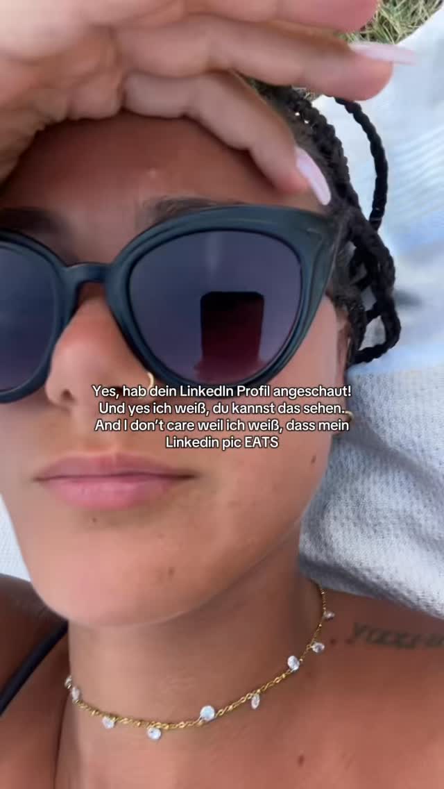 The cover image is a selfie featuring a woman's face from the chest up. She's wearing sunglasses, and her hand is near her forehead. Her hair is styled in braids. There is text overlaid on the image. In the background, a suggestion of a beach setting with light-colored material. The composition is focused, creating a sense of intimacy.