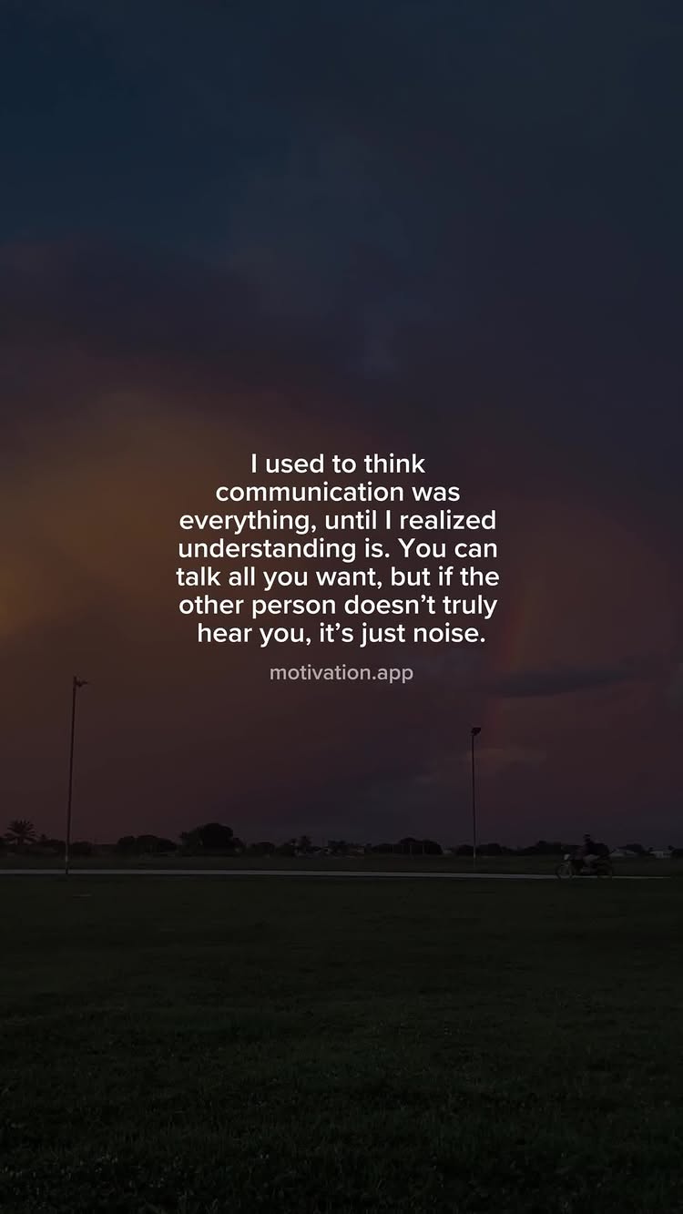 The image shows a dark, outdoor scene, likely at dusk or night. The primary focus is a text overlay that presents a motivational quote. The sky is a gradient of dark blues and purples, with a few distant streetlights providing a subtle glow. In the foreground, there's a grassy area, and the overall composition is simple and clean, making the text the clear emphasis.