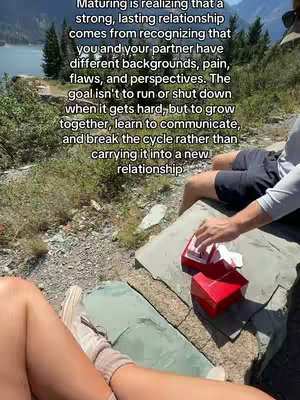 The cover image shows a scenic outdoor setting with a lake in the background. The foreground features a pair of legs with neutral-toned sneakers and a person is reaching for a red box. The text overlay contains relationship advice.