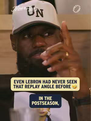 LeBron James, wearing a white cap with black trim and the letters 'UN', points upward with a serious expression. Text overlays read 'EVEN LEBRON HAD NEVER SEEN THAT REPLAY ANGLE BEFORE' and 'IN THE POSTSEASON', with a blurred image of a person and additional text in the background.