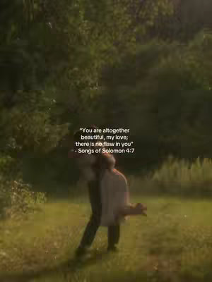 A romantic cover image showing a couple embracing in a field. The background is blurred with greenery, and light filters through the trees. The couple is embracing, with one person leaning on the other. Text in white is overlaid on the image, providing a quote. The overall tone is warm and loving.