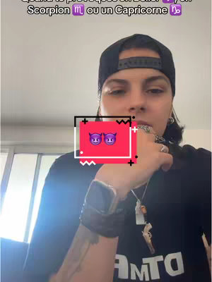 A person wearing a black cap and shirt is looking at the camera with a thoughtful expression, their hand near their chin. A red box with two devil emojis is in the middle of the image, with some text that reads "Quand te provoques en Belier ?" above it.