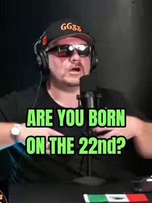 A middle-aged man wearing a black baseball cap, sunglasses, and headphones is positioned in front of a microphone. Text overlays are added on the image. The background appears to be a dark or dimly lit space.