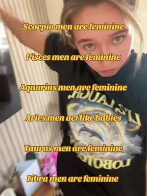 A selfie-style video cover shows a young woman with fair skin and light-colored hair, angled slightly from above. She is wearing a dark t-shirt and looking towards the camera with a neutral expression. Text overlays in a warm yellow color are stacked vertically. The background is blurred, suggesting an interior setting.