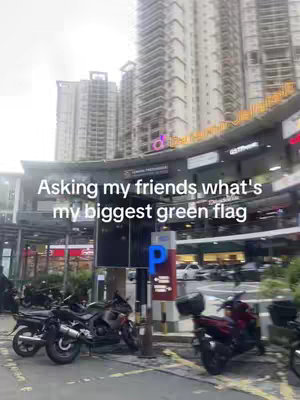 An outdoor shot of a modern plaza with tall buildings in the background. In the foreground, there are parked motorcycles, with a parking sign in the center. The text overlayed on the image asks viewers a question.