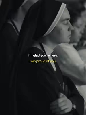 A black and white photo featuring a nun in a traditional habit. The nun's face is in profile, looking downwards with a contemplative expression. Overlayed text reads, 'I'm glad you're here. I am proud of you.'