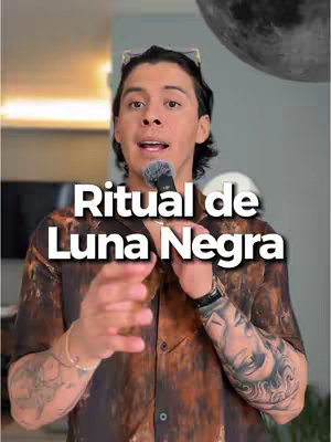 The cover image features a man holding a microphone, with the words "Ritual de Luna Negra" overlaid in large, white text. He's wearing a brown, patterned shirt and has tattoos on his arms. The background is blurred, suggesting an indoor setting with neutral colors.