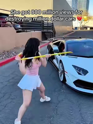 A woman is shown mid-stride, wielding a yellow object, presumably to hit a white sports car. Text overlays the image, stating the woman received a lot of views for destroying the cars.