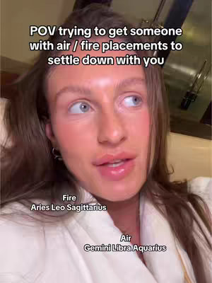 A woman with fair skin and brown hair looks slightly off-camera, presumably talking. Text overlays and graphic elements denote the video's astrology focus. The background is indistinct, suggesting a close-up or indoor setting.