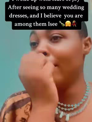 Close-up of a woman with fair skin and a slightly sad expression, hand covering her mouth, wearing a patterned top, and a turquoise beaded necklace, with text overlayed on the top.