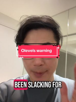 A selfie-style shot featuring a man in the center, appearing to look straight at the camera. The background seems to be a domestic interior, slightly out of focus. The man wears glasses and a gray long-sleeved shirt. Text overlays are positioned on the image.