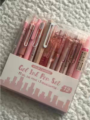 The cover image displays a package of gel ink pens in various shades of pink. They are neatly arranged in a clear plastic box. The packaging includes text that reads 'Gel Ink Pen Set' and contains a drawing of a city skyline.