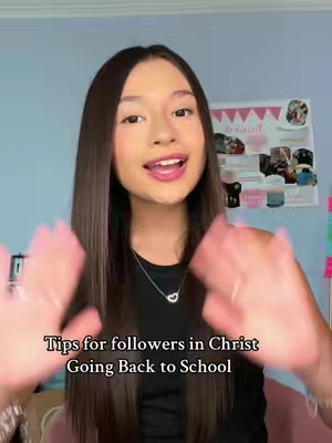 A light-skinned young woman with long, straight brown hair smiling. She is wearing a black top and a necklace with a heart pendant. Her hands are raised, with her palms facing outwards, and the fingers are curved inward as if she is holding something. The background is a light blue wall with some photos and papers. The hook text is overlaid at the bottom.