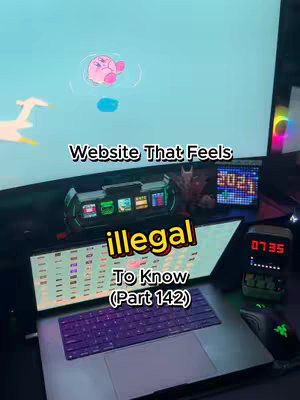 The image shows a desk setup with a laptop open, displaying code or website elements. There is a monitor in the background with a cartoon image of Kirby. The tagline "Website That Feels Illegal To Know" is overlaid on the image. Various technological items are scattered across the desk, creating a very tech-focused aesthetic. The overall composition is well-lit and presents a modern tech and software content.