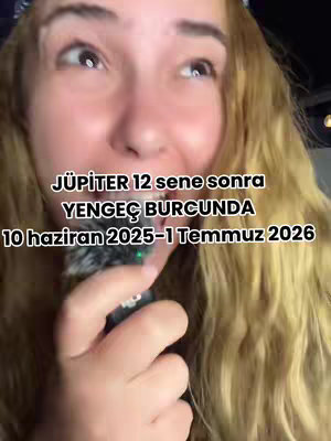 A close-up shot of a woman with long, wavy blonde hair looking upwards with a slight smile. Text overlays the image, providing information about Jupiter's astrological position.