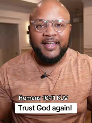 A bald man with a beard and glasses is looking directly at the camera with a slight smile. He wears a brown shirt. Text overlays at the bottom includes a bible verse reference with the message: Trust God again!