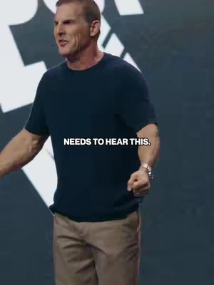 A man in a dark blue t-shirt and khaki pants is standing in front of a blurred background with text overlay. The hook says: NEEDS TO HEAR THIS.